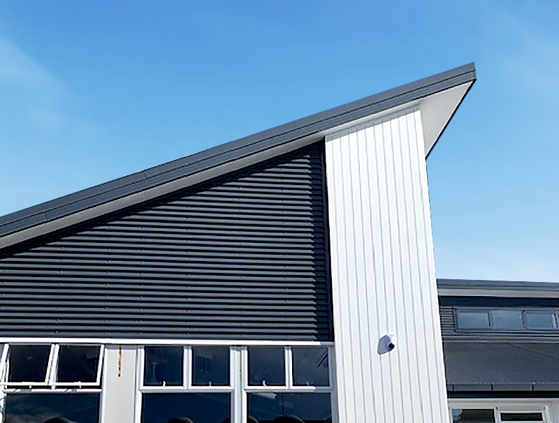 Clifton Terrace School: a dark metal roof over white-framed classroom windows