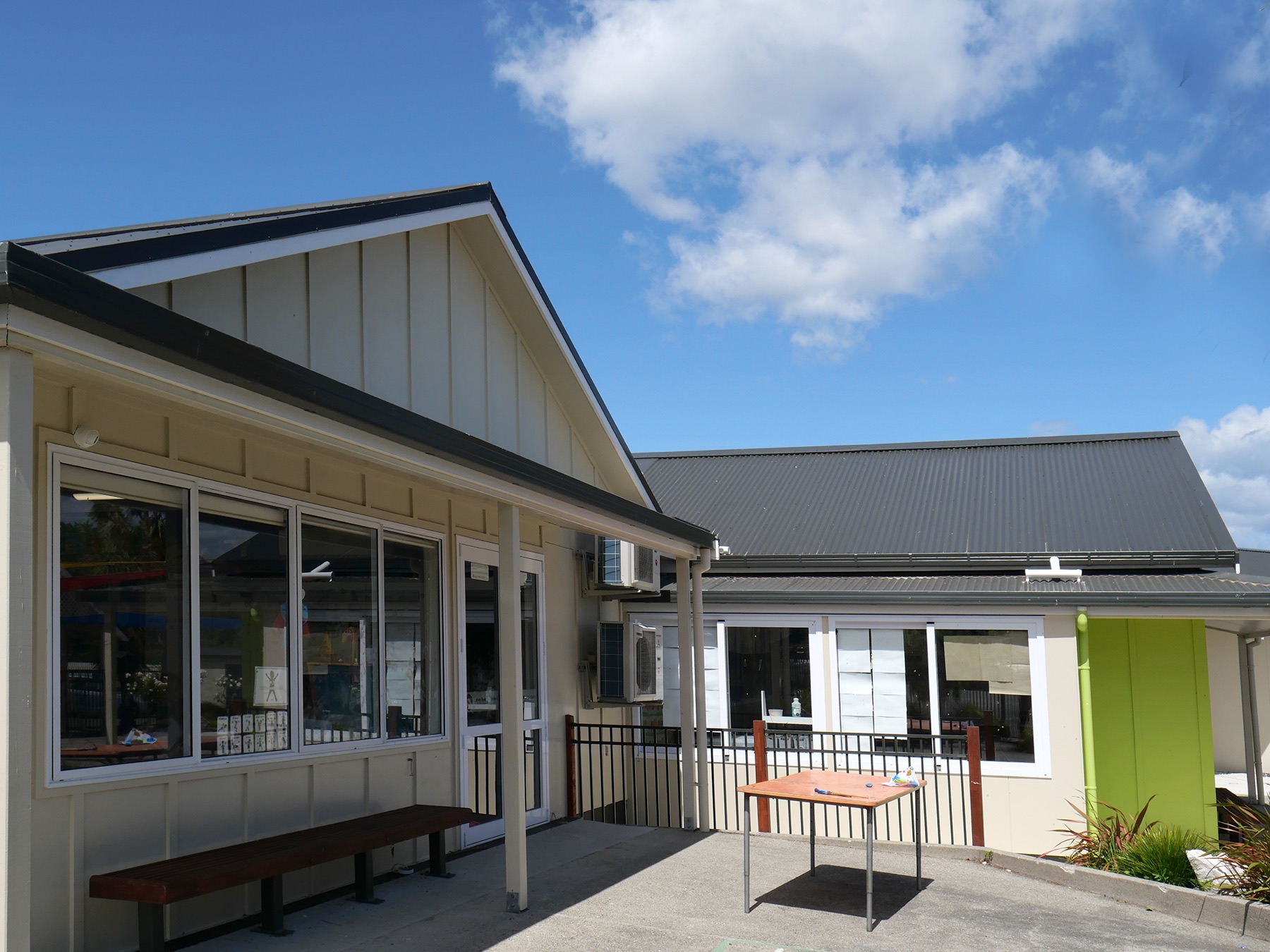 Lower Moutere School: cream and lime green classroom blocks around a courtyard