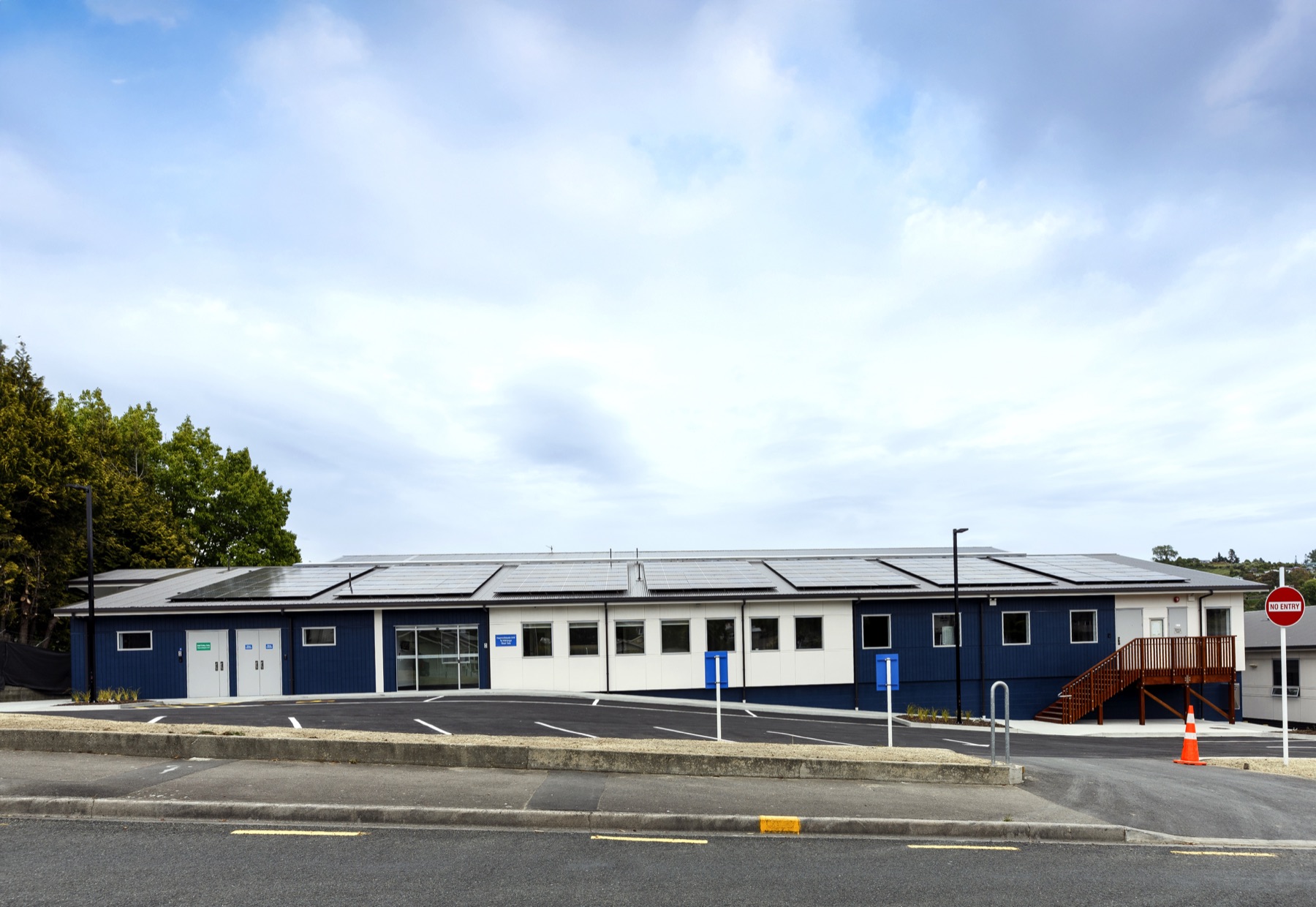 A long blue and white healthcare accommodation building at Nelson Hospital